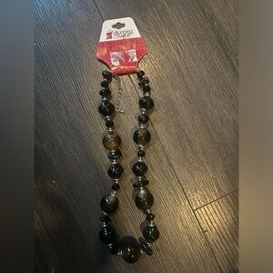 Mom's never worn Charming Charlie Brown with silver.